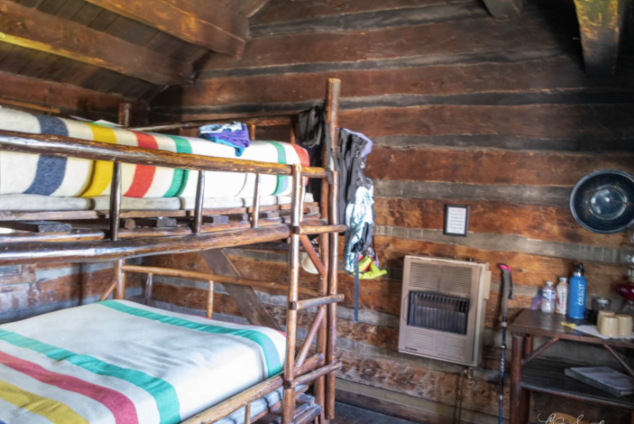 Two bunk beds in a rustic cabin