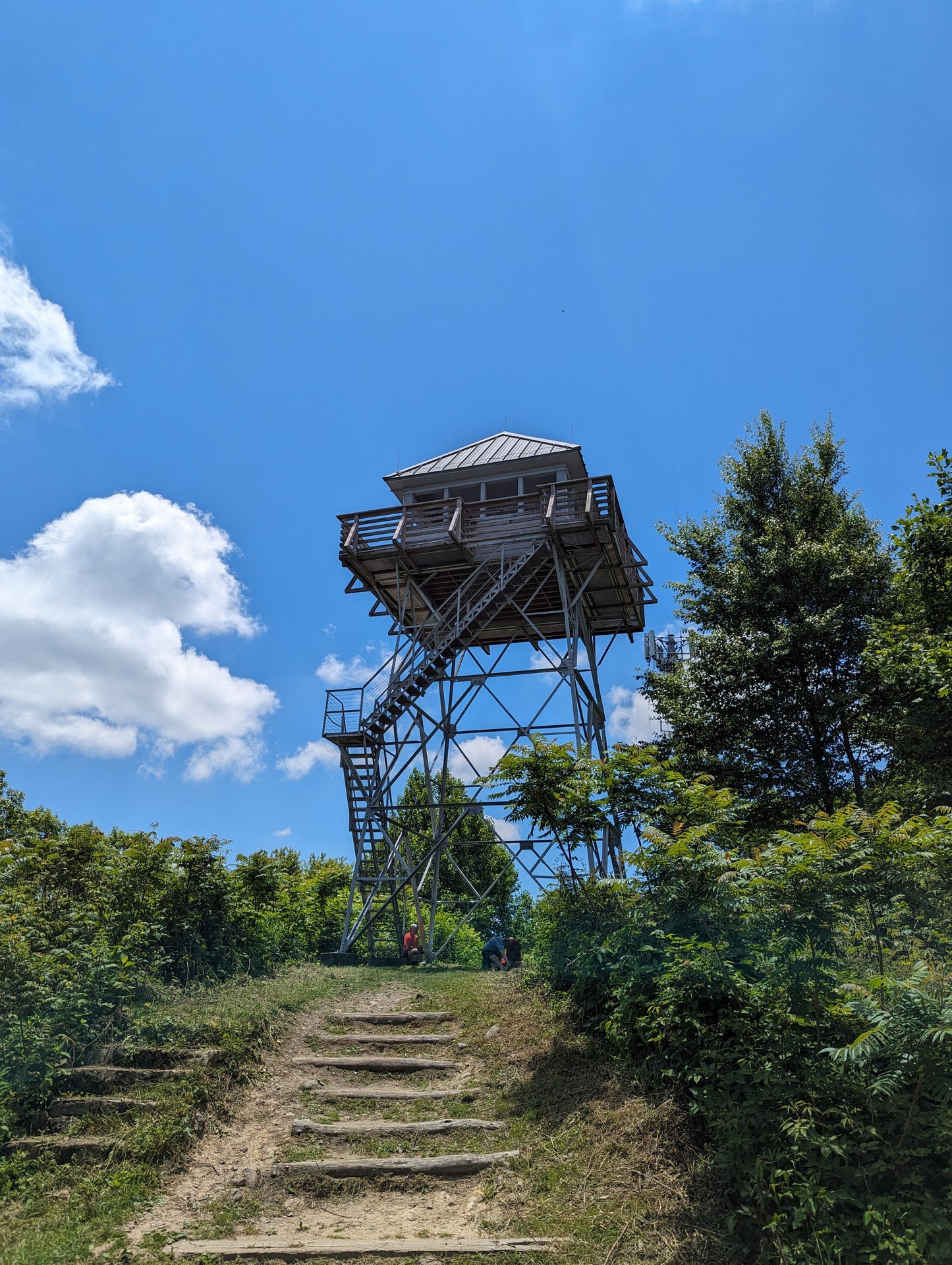 A wooden fire tower with stairs leading to the top